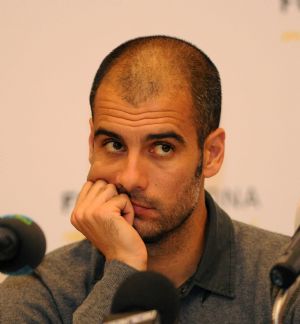 Barcelona&apos;s coach Pep Guardiola listens to questions during a news conference at Movenpick hotel in Kuwait City December 20, 2009. Barcelona will play Kuwait&apos;s Kazma Sporting Club in a friendly soccer match on Monday.