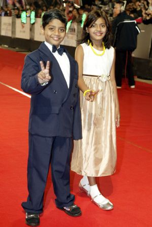 Indian teenage movie star Azharuddin Ismail (L) and Rubina, who co-starred the India film Slumdog Millionaire, walk on the Star Boulevard, during the awarding ceremony held at the I-Sho University in Kaoshiung of southeast China&apos;s Taiwan Province on Dec. 19, 2009. The 53rd Asia Pacific Film Festival attracted 58 films from 14 nations and regions who are members of this regional film festival. Some 500 delegates took part in the award-presentation ceremony. (Xinhua)