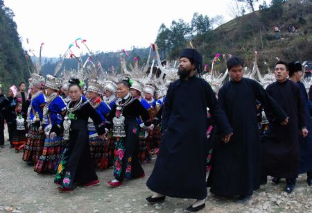 People of the Miao ethnic group perform traditional dance during the closing celebration of the Guzang Festival at Wuliu Village in Leishan County, southwest China&apos;s Guizhou Province, Dec. 19, 2009. The Guzang Festival, one of the grandest festivals of the Miao ethnic group to commemorate their ancestors, was held here from Nov. 27 to Dec. 19. (Xinhua/Chen Peiliang)