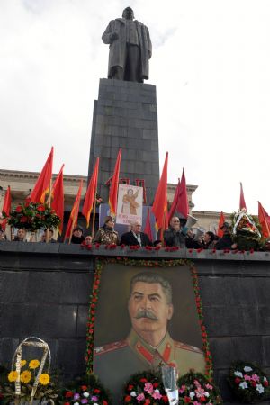 People attend the memorial ceremony marking the 130th anniversary of Josef Stalin&apos;s birthday in front of his bronze in Gori, Georgia, Dec. 21, 2009. Some Georgians came to Gori, where Josef Stalin was born 130 years ago, to pay tribute to the Soviet leader on Monday.