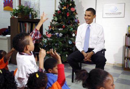 U.S. President Barack Obama talks to children during a visit to a Boys and Girls Club in northeast Washington December 21, 2009. Obama read the Christmas story 