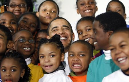 U.S. President Barack Obama poses with children during a visit to a Boys and Girls Club in northeast Washington December 21, 2009. 