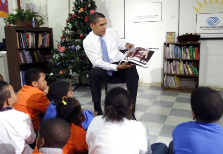 U.S. President Barack Obama reads the Christmas book "The Polar Express" to children during a visit to a Boys and Girls Club in northeast Washington December 21, 2009.