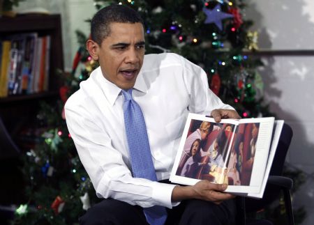 U.S. President Barack Obama reads the Christmas book "The Polar Express" to children during a visit to a Boys and Girls Club in northeast Washington December 21, 2009.