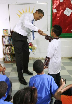 U.S. President Barack Obama fist bumps with a boy during his visit to a Boys and Girls Club in northeast Washington December 21, 2009.