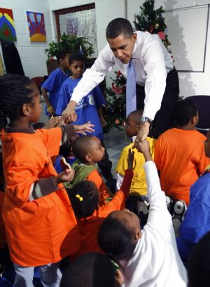 U.S. President Barack Obama greets children during a visit to a Boys and Girls Club in northeast Washington December 21, 2009.