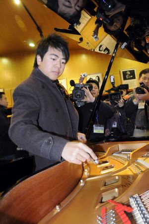 Chinese pianist Lang Lang signs on the piano named after Lang Lang as he visits Shenzhen in south China&apos;s Guangdong Province on Dec. 21, 2009. Lang Lang played a unison with 100 children in the city.