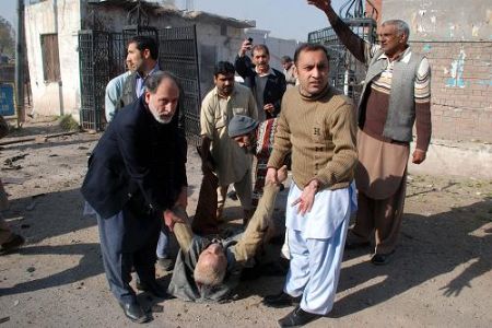 An injured person was moved to get treatment at the site of blast in the northwestern Pakistani city of Peshawar, Dec. 22, 2009.