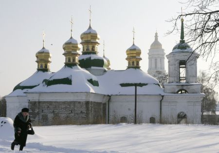 A woman passes by a church after heavy snowfall in central Kiev, December 21, 2009.