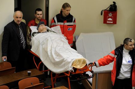 Accused Nazi death camp guard John Demjanjuk is brought in a courtroom in Munich December 22, 2009. The trial of Demjanjuk, an 89-year-old former U.S. auto worker, facing charges he helped force 27,900 Jews into gas chambers in Sobibor extermination camp in 1943, resumed on Monday. 