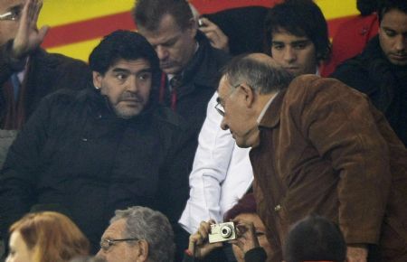 Argentina&apos;s coach Diego Maradona (L) is seen in the crowd during a friendly soccer match against Catalunya at Camp Nou stadium in Barcelona, December 22, 2009.