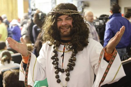 A man dressed as Jesus smiles as he attends the draw for the world