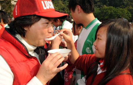 Students salute to parents and teachers to show their thanksgiving courtesy in an activity of making sweet soup dumplings at a middle school in Taipei, southeast China&apos;s Taiwan. 