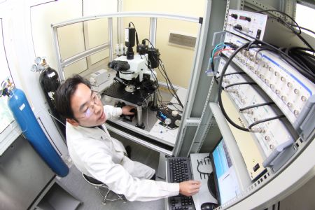 A resercher operates at the Laboratory of the Tianjin Medical University in north China&apos;s Tianjin municipality on Dec. 23, 2009. The Tianjin Neural Engineering Research Centre is formed on Wednesday as a result of cooperation between Tainjian Medical University and Tianjin University. (Xinhua/Li Xiang) 