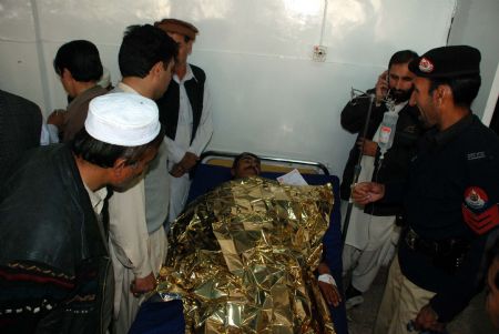 A man injured in a bombing receives medical treatment at the Lady Ready hospital in the northwestern Pakistani city of Peshawar, on Dec. 24, 2009. At least four people were killed and 11 others injured on Thursday in a suicide bombing in Peshawar, according to local TV reports. (Xinhua/Umar Qayyum)