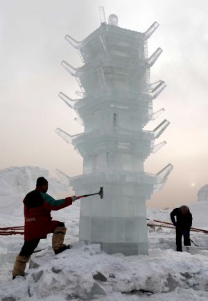 Technicians from Harbin, northeast China&apos;s Heilongjiang Province, work on an ice sculpture in Hexigten Qi in north China&apos;s Inner Mongolia Autonomous Region, Dec. 25, 2009. Over 30 ice sculpture makers from Harbin arrived in Hexigten Qi to set up an ice sculpture park.