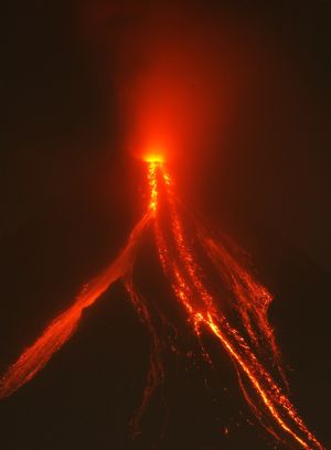 Mayon volcano spews ash and glowing lava cascades down its slope during a continuing mild eruption of Mayon volcano in Legazpi City, Albay province, south of Manila December 24, 2009. The Philippines' most active volcano shot higher ash columns and rumbled louder on Wednesday as authorities warned of a potential hazardous eruption in Mount Mayon anytime.