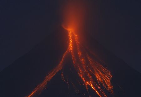 Mayon volcano's glowing lava cascades down its slope during a continuing mild eruption of Mayon volcano in Legazpi City, Albay province, south of Manila December 24, 2009.