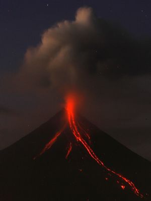 Mayon volcano spews ash and glowing lava cascades down its slope during a continuing mild eruption of Mayon volcano in Legazpi City, Albay province, south of Manila December 24, 2009.
