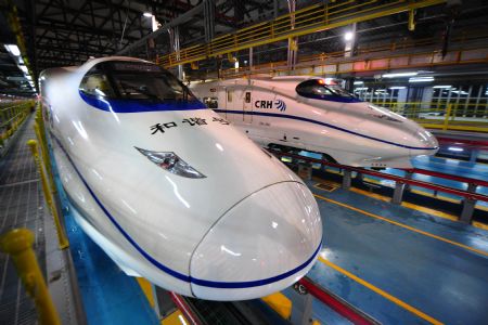 Two high-speed trains stop at the high-speed railway maintenance base in Wuhan, capital of central China's Hubei Province, Dec. 22, 2009. This base is one of the four high-speed train maintenance bases in China. The Wuhan-Guangzhou high-speed railway, a 1,068.6-kilometer passenger rail line linking Wuhan and Guangzhou, capital of south China's Guangdong Province, will be formally opened on Dec. 26. [Cheng Min/Xinhua