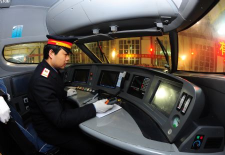 A driver operates a high-speed train at the high-speed railway maintenance base in Wuhan, capital of central China's Hubei Province, Dec. 26, 2009. [Xinhua/Cheng Min]