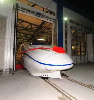 A high-speed train runs out of the high-speed railway maintenance base, in Wuhan, capital of central China's Hubei Province, Dec. 26, 2009.