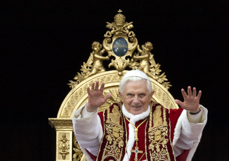 Pope Benedict XVI blesses the faithful as he leads his Urbi et Orbi (to the city and the world) Christmas Day message from the central balcony of Saint Peter's Square at the Vatican December 25, 2009.