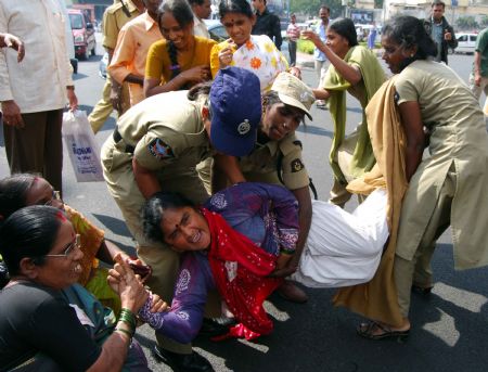 Police detain activists in front of Raj Bhavan in Hyderabad on Dec. 26, 2009 as members of women organizations demonstrating to demand the punishment on N.D.Twari, the Governor of Indian state of Andhra Pradesh, on his alleged involvement in sex scandal. The Governor of Andhra Pradesh N.D.Twari resigned on Saturday.