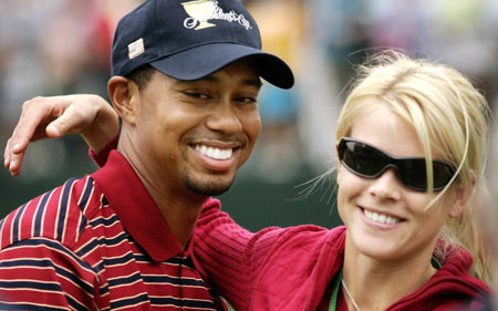 U.S. golfer Tiger Woods gets a hug from his wife Elin Nordegren on the 18th green at the Presidents Cup in Gainesville, Virginia, in this September 24, 2005 file photo. Elin has given birth to their first child, Woods said in a statement on his Web site on June 19, 2007. 