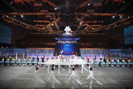 The flag of 24th World Winter Universiade is escorted into Harbin International Conference, Exhibition and Sports Centre Gym at the opening ceremony of the 24th World Winter Universiade in Harbin, capital of northeast China&apos;s Heilongjiang Province, Feb.18, 2009. (Xinhua File Photo)