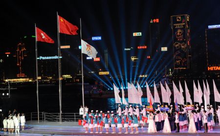 China&apos;s national flag and the flag of China&apos;s Hong Kong Special Administrative Region are raised during the opening ceremony of the 2009 East Asian Games in Hong Kong, south China, Dec. 5, 2009. (Xinhua File Photo)