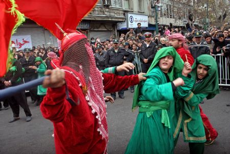 Iranians take part in a performance depicting the story of Imam Hussein on the final day of Ashura in Tehran, capital of Iran, Dec. 27, 2009.