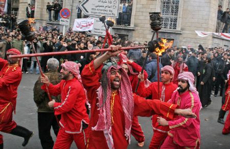  Iranians take part in a performance depicting the story of Imam Hussein on the final day of Ashura in Tehran, capital of Iran, Dec. 27, 2009. Ashura, the most important day in the Shi'ite calendar, commemorates the death of Imam Hussein, grandson of the Prophet Mohammad, in the 7th century battle of Kerbala.