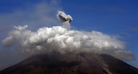 The partially covered Mayon volcano spews a column of ash during another mild eruption in Legazpi City, Albay province, south of Manila December 28, 2009.