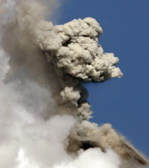 The partially covered Mayon volcano spews a column of ash during another mild eruption in Legazpi City, Albay province, south of Manila December 28, 2009.