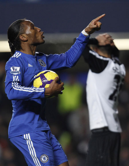 Chelsea's Didier Drogba (L) celebrates after scoring against Fulham during their English Premier League soccer match at Stamford Bridge in London December 28, 2009.  