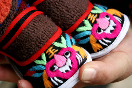 Photo taken on Dec. 28, 2009 shows a pair of handmade "Tiger Shoes", traditional Chinese cloth shoes for children, in Taoshan Township in Hanshan County, east China