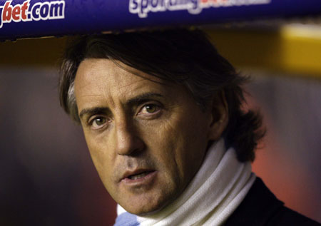 Manchester City's manager Roberto Mancini takes his seat for their English Premier League soccer match against Wolverhampton Wanderers at Molineux in Wolverhampton, central England, December 28, 2009. 