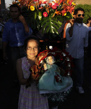 A girl holds a doll representing Jesus Christ as a child as she participates in a traditional procession celebrating Holy Innocents Children's Day at Antiguo Cuscatlan, 3 km (2 miles) east of San Salvador on December 28, 2009. 