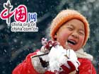 A Chinese boy plays with the snow on in Jiaxing, Zhejiang Province. Recently, a fresh snow spread over most of China.