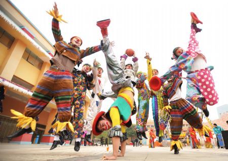 Clowns perform for audience in a park in Changsha, capital of central China's Hunan Province, to celebrate the upcoming new year, Dec. 29, 2009.