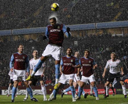 Aston Villa's John Carew heads the ball clear during their English Premier League soccer match against Liverpool at Villa Park in Birmingham, central England, December 29, 2009.(Xinhua/Reuters Photo)