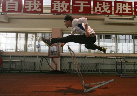 Liu Xiang, athlete of men's 110 metres hurdles race, strides over the hurdles during the first open winter training session of the China's national team of track and field, at the Xingzhuang Training Base, in Shanghai, east China, on Dec. 29, 2009. (Xinhua/Fan Xiaoming)