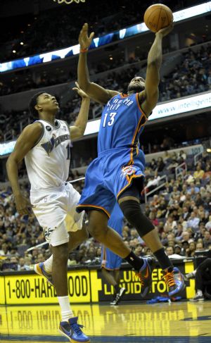 Oklahoma City Thunder's James Harden (R) goes up for a shot during the NBA basketball game with Washington Wizards in Washington, the United States, on Dec. 29, 2009. Wizards lost 98-110. (Xinhua/Zhang Yan)