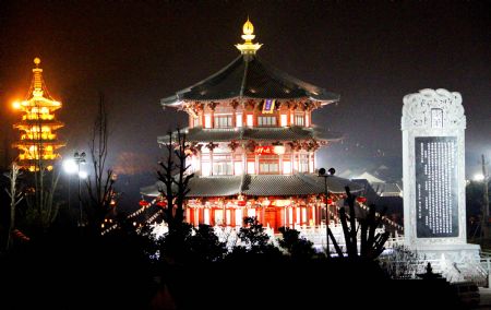 The Giant Bell and Stele Garden outside of the Hanshan Temple flare and scintillate in grand illumination, in Suzhou, east China&apos;s Jiangsu Province, Dec. 29, 2009. The bell tower, pagoda, the Giant Bell and Stele Garden and other major scenic spots of the Hanshan Temple are invariably lightened on in an ebullient illumination to usher in the traditional New Year&apos;s Eve Bell Ringing activity on the night of Dec 31, as some 6,000 guests and sightseers are set to take part in. [Wang Jianzhong/Xinhua]