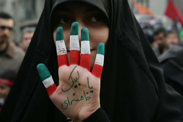 An Iranian demonstrator holds up her hand painted like the Iranian flag with the palm saying &apos; We are ready for your order, Khamenei&apos; during pro-government rallies in Tehran, Iran on December 30, 2009. Hundreds of thousands of supporters of Iranian President Mahmoud Ahmadinejad staged state-sponsored demonstrations throughout the country against the opposition. [CFP]