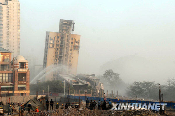 Half of a building leans but fails to fall while the other half collapses after a blasting at the scene of demolition in Liuzhou city, Guangxi Zhuang Autonomous Region on December 30, 2009. The demolition failed due to technical reasons.[Xinhua]