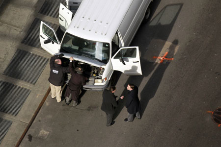 Emergency services personnel inspect a van that has been declared a 