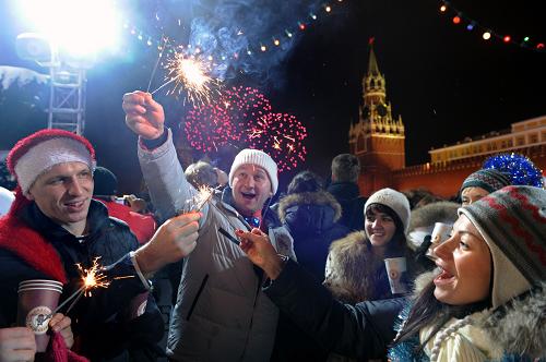 People gather to celebrate New Year's Eve on Red Square in Moscow on January 1st, 2010. Some 120,000 Russians crowded overnight on Moscow's Red Square to toast the year 2010, as President Dmitry Medvedev thanked his nation for bearing with the economic crisis and evoked family values. 