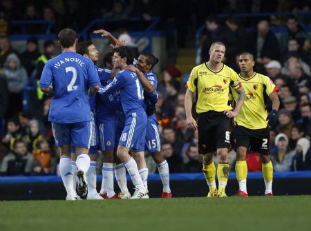 Watford's Jay Demeri (C) and Adrian Mariappa (R) walk past Chelsea players congatulating Yury Zhirkov following his goal during their FA Cup soccer match at Stamford Bridge in London, Jan. 3, 2010.(Xinhua/Reuters Photo) 